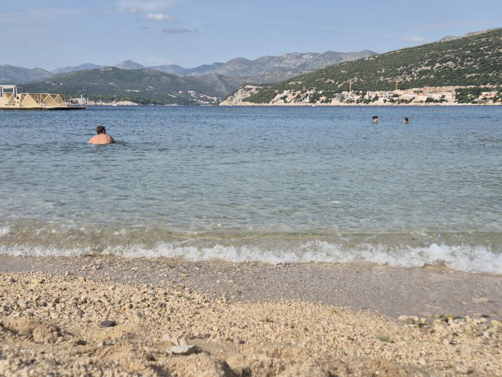 Copacabana Beach in Dubrovnik with crystal-clear waters, perfect for sunbathing and swimming, located in the Babin Kuk area.