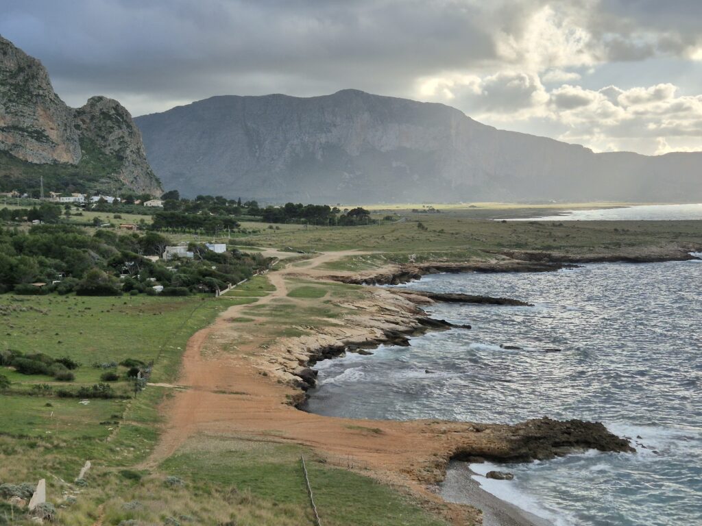 A mesmerizing coastal view along the drive from Castellammare del Golfo to San Vito Lo Capo, featuring rugged cliffs, crystal-clear turquoise waters, and untouched Mediterranean landscapes. A scenic route showcasing Sicily’s breathtaking natural beauty.