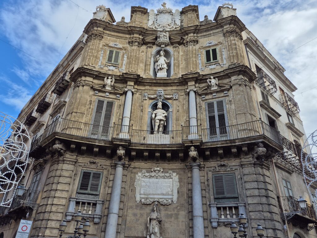 A vibrant view of Quattro Canti, Palermo’s historic Baroque square, with four ornate facades and lively street scenes capturing the city's charm.