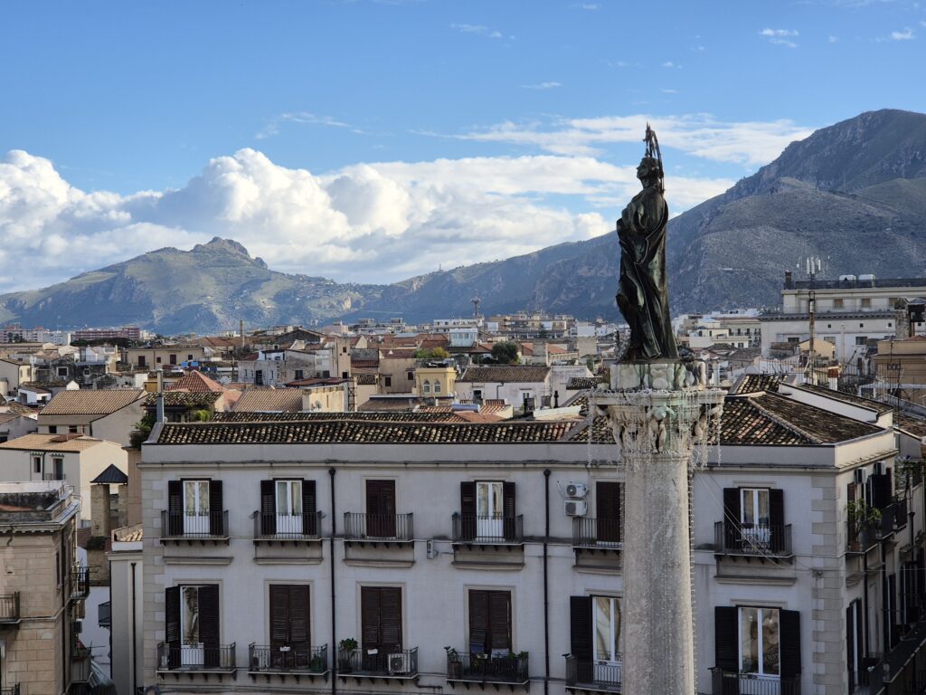 A breathtaking view from Il Bar's rooftop in Piazza San Domenico, offering a sweeping look at Palermo's rooftops, charming streets, and the distant hills, perfect for enjoying an afternoon coffee.