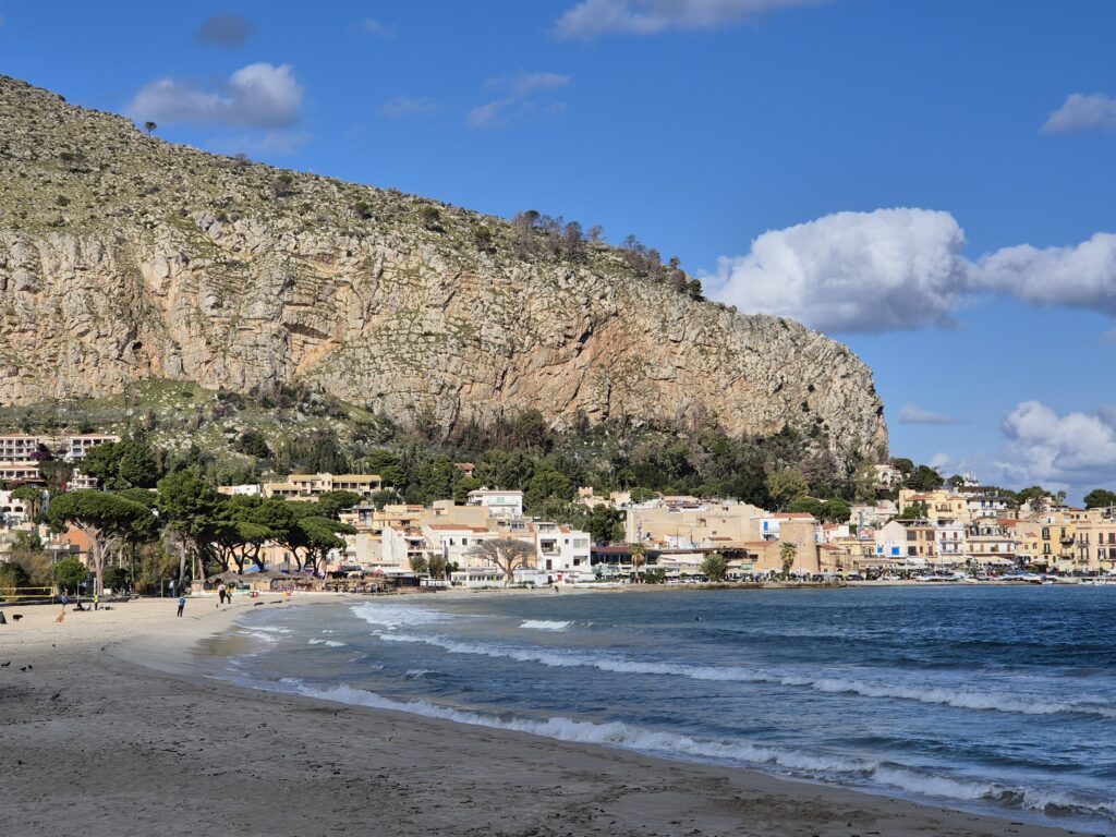 A serene seaside view of Ombelico del Mondo, with the calming waves of the Mediterranean gently lapping against the coastline, offering a peaceful escape in the heart of Palermo.