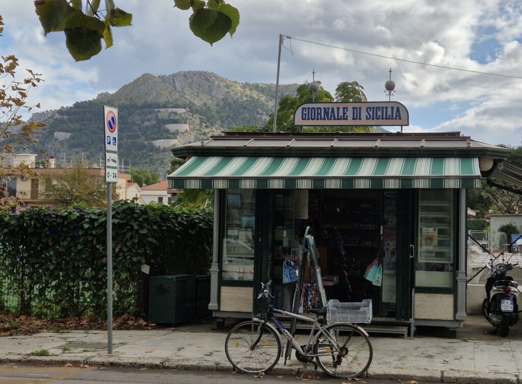 A charming Sicilian kiosk selling local snacks and beverages, with its colorful design and lively atmosphere, typical of the island’s vibrant street culture.